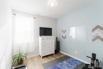 Versatile bedroom #2 currently staged as a home gym with space for equipment, yoga, or fitness routines.