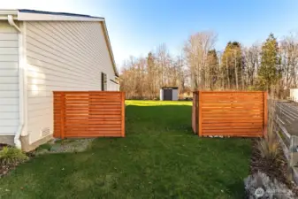 Custom cedar double gate entry connecting the backyard to the front yard and neighborhood access.