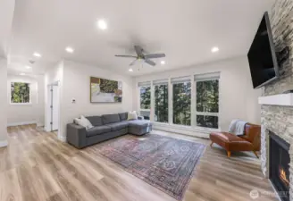 Living space with fireplace, media wall, and flexible furniture layout options.