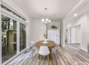 Dining area positioned next to sliding glass door for easy indoor-outdoor access.