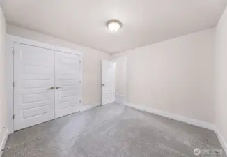 Secondary bedroom with large window and natural light