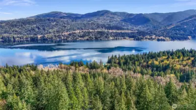 Elevated aerial showing wooded surroundings and lake views