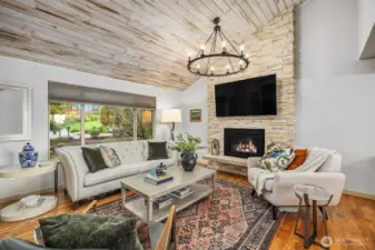 The soft grey blue walls pick up the colors in the stacked stones. Love the modern chandelier, one of many lighting upgrades.