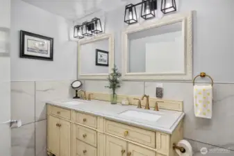 Gorgeous new lower level bath, with double vanity and tile surround.