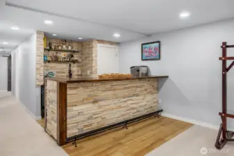 The highlight of the new lower family/great room is this stacked stone wet bar. Love the glazed wood top and trim. Seating space for many 'patrons'.