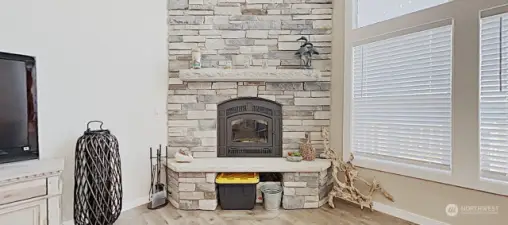 Floor-to-ceiling stone fireplace adds warmth and intimacy