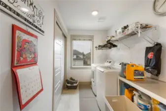 Large laundry room with closets located upstairs.