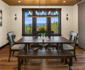 Spacious dining room with view of the mountains and custom lighting.