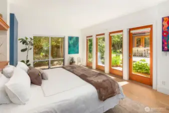 French doors lead from the primary bedroom to the courtyard.