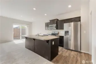 Open kitchen, fridge to stay, huge walk in pantry to the right.