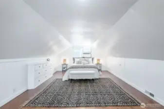Enjoy this spacious, bright primary bedroom.