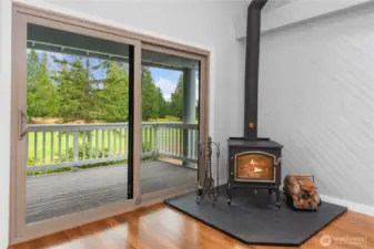 A newer sliding door off the living room opens to a west-facing covered deck with serene golf course and wooded views. The environmentally friendly fireplace heats the whole condo and a large wood-pile comes with it.