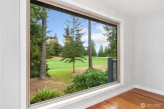 The sellers remodeled this wall by installing a huge, triple-paned window to bring in the views of the golf course and woods. Private and lovely, this elevated room is filled with natural light and beauty.