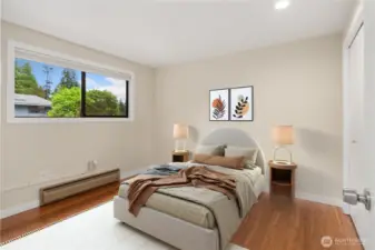 The first of two guest bedrooms, this lovely room has hardwood floors, a spacious closet, and window coverings.