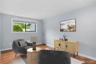 The second guest bedroom is staged as a den, and was used as a den by the sellers. In the background you'll see a door that leads to the one-car garage - brilliant!  Easy to unload the groceries from the car to the kitchen, especially in the winter time.