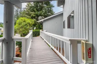 Another view of the breezeway, which will undergo repairs in Sept. 2025 to insure lasting use and safety. The siding is wood, the roof is composite, and many of the windows in the condo have been replaced and upgraded.