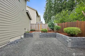 View from patio to part of backyard. Fully fenced and private. Professional landscaped.