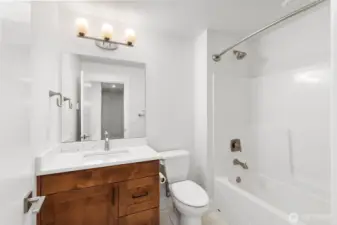 Bright full bath on lower level with modern vanity, tub/shower combo.