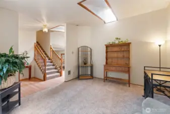 Living room or office off the front entry with a skylight that lends natural light to the room.