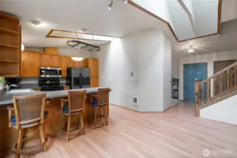 Durable laminate flooring in the entry, kitchen and dining areas and more skylights.
