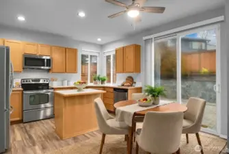 Kitchen with eating area, stainless steel appliances, LVP flooring, and backyard access