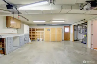 2 car garage with storage and work benches. Door out to fully fenced back yard
