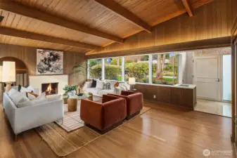 Stone gas fireplace is the centerpiece of the living room and the signature wood cantilevered ceilings immediately create a warm and inviting aesthetic.