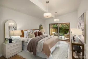 Private primary suite with walk-in closet and sliding glass doors to a tranquil deck.