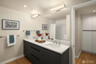 Hall bathroom servicing the two bedrooms. Notice the hall linen closet for storage.