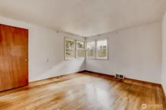 Main Floor Bedroom #1. Original hardwood floor and plenty of windows for great natural light.