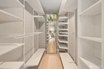 Spacious walk-in closet with custom built-ins.