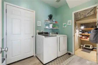 updated main floor laundry room has newer washer & dryer, tons of storage and folding counter.