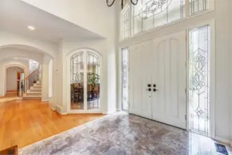 Two Story Foyer With Custom Molding And Leaded Glass Accents.