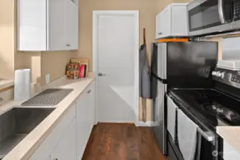 Stainless steel appliances coordinate, complementing crisp white cabinetry.