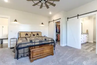 Main Floor Primary Bedroom with Custom barn doors and walk in closet