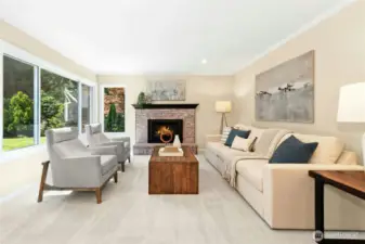 Large family room with gas fireplace and abundance of natural light.