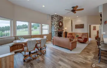 Looking toward the primary suite.. The lovely stone fireplace is a calming focal point.