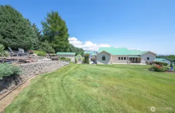 Upper yard, water feature and a glimpse of the green house