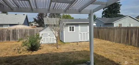 fenced backyard with garded sheds