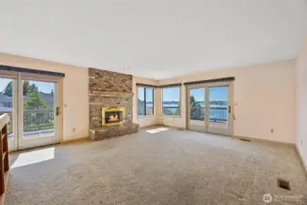 Living Room with wood fireplace and access to the wrap-around deck