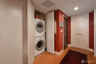 This shows the entry door (brown one)  and washer and dryer. And huge pantry (the double white doors)