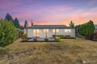 Fully fenced backyard with a covered patio—perfect for summer BBQs or relaxing mornings