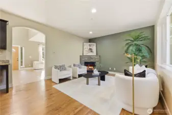 Beyond the front entryway, a second living room/family room awaits featuring a cozy gas fireplace and large windows which provide tons of natural light to the space