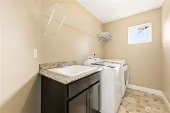 Spacious laundry room with a convenient utility sink