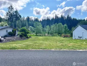 Property located between two homes and located adjacent to desiganted forest land. Trails behind property.