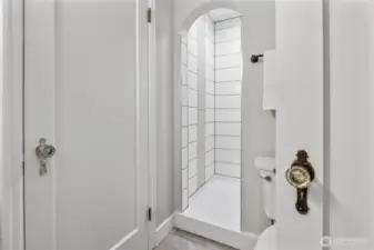 3/4 bathroom on main floor with custom tiled shower