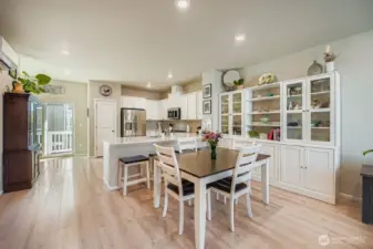 Space enjoys both bar seating and dining area in open concept room.