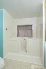 Primary bathroom with a wonderful step-in tub!  There is also a separate shower, too.