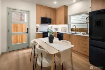 Seamless flow between the kitchen and dining areas, highlighted by clean lines and an abundance of natural light.