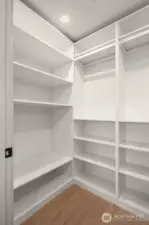 Custom-built storage room with extensive shelving, ideal for use as a large pantry or linen closet.